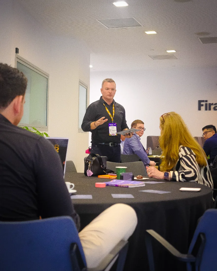 Leo Judkins presenting to a small seated group during a live session